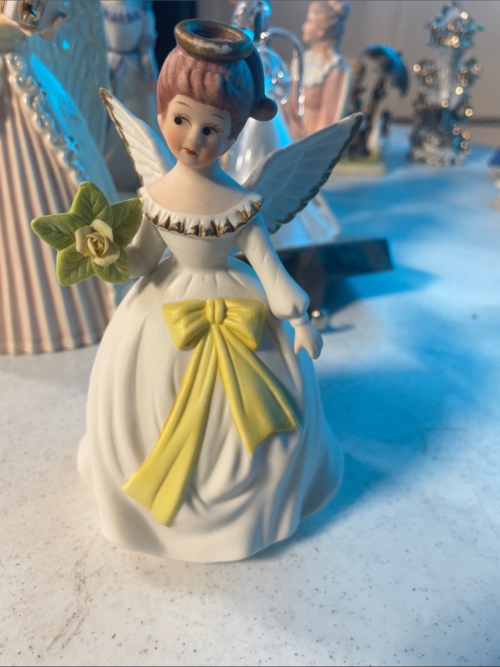 Porcelain Angel Figurine with Yellow Bow and Green Flower